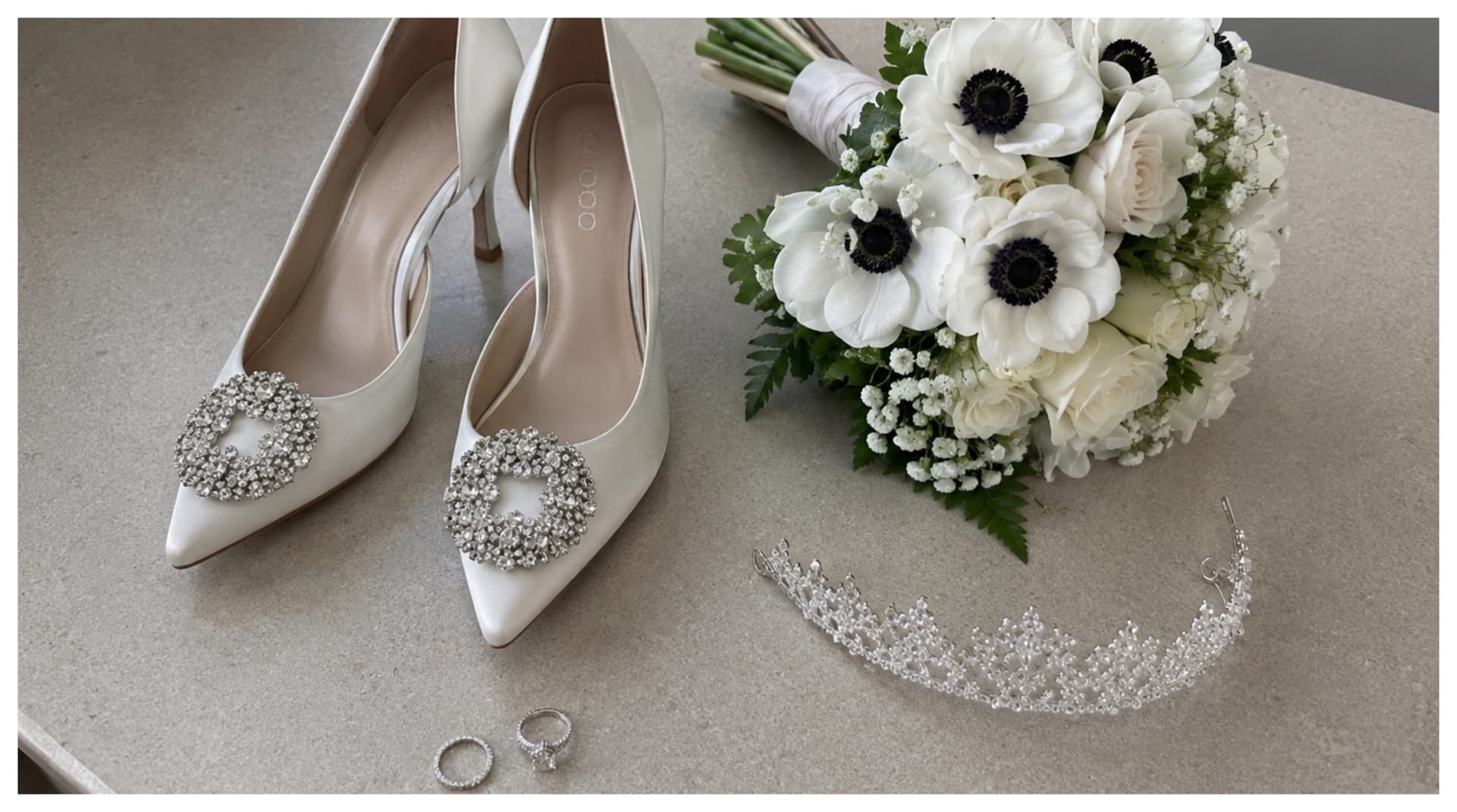 Wedding album spread featuring bridal shoes and flowers